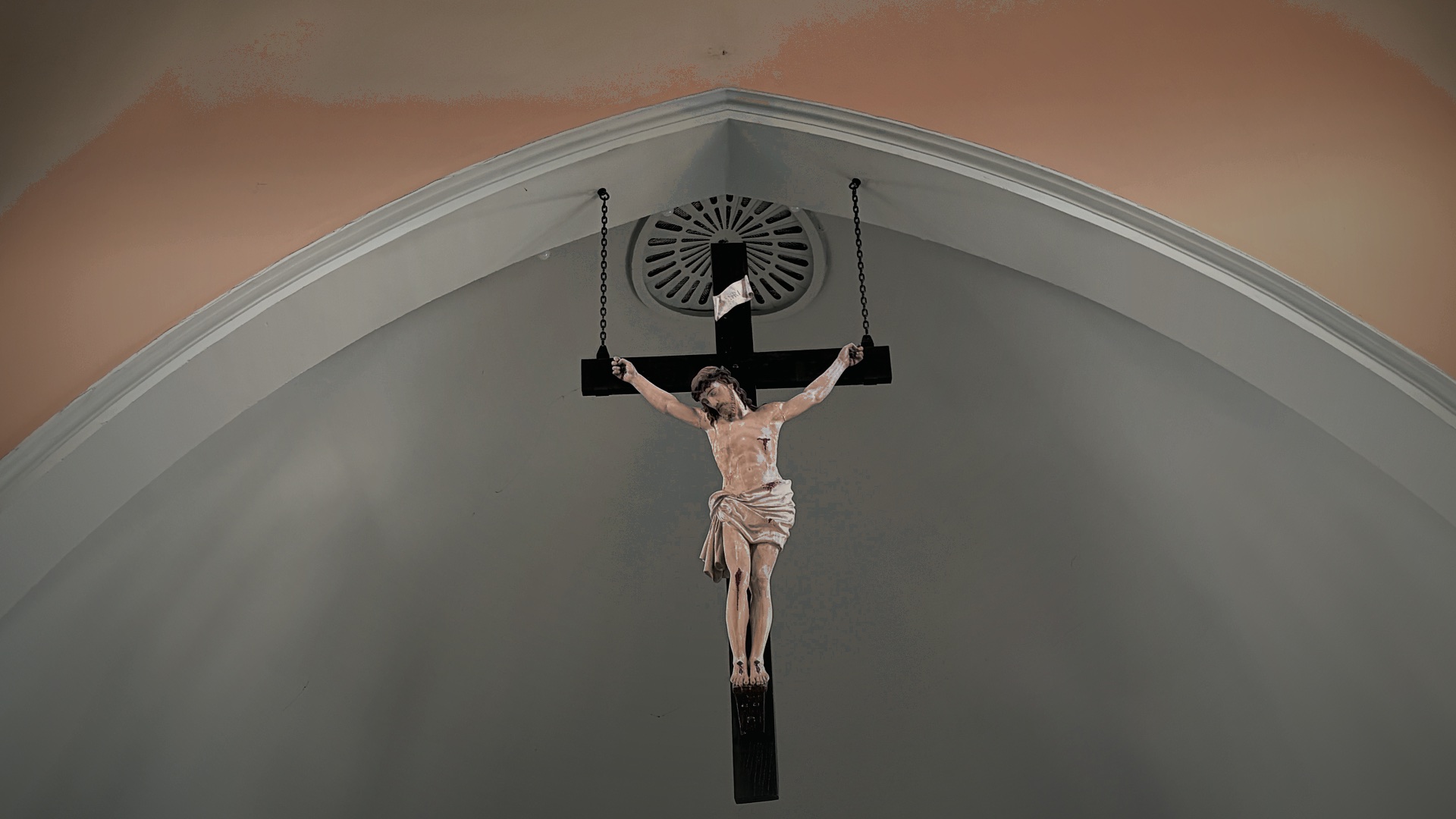 A crucifix set within a stone arch at St. James