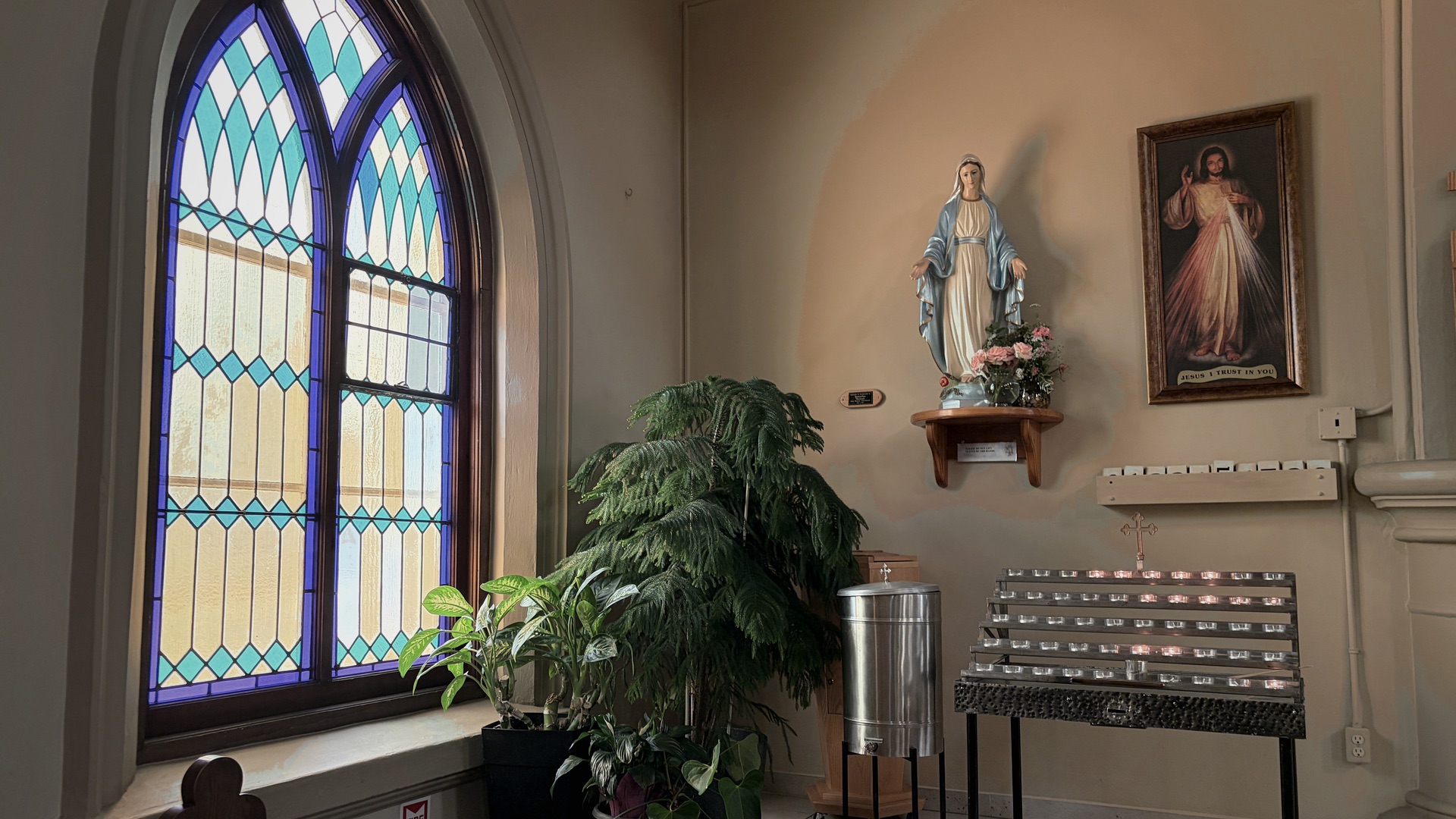 A tall stained-glass window in St. James