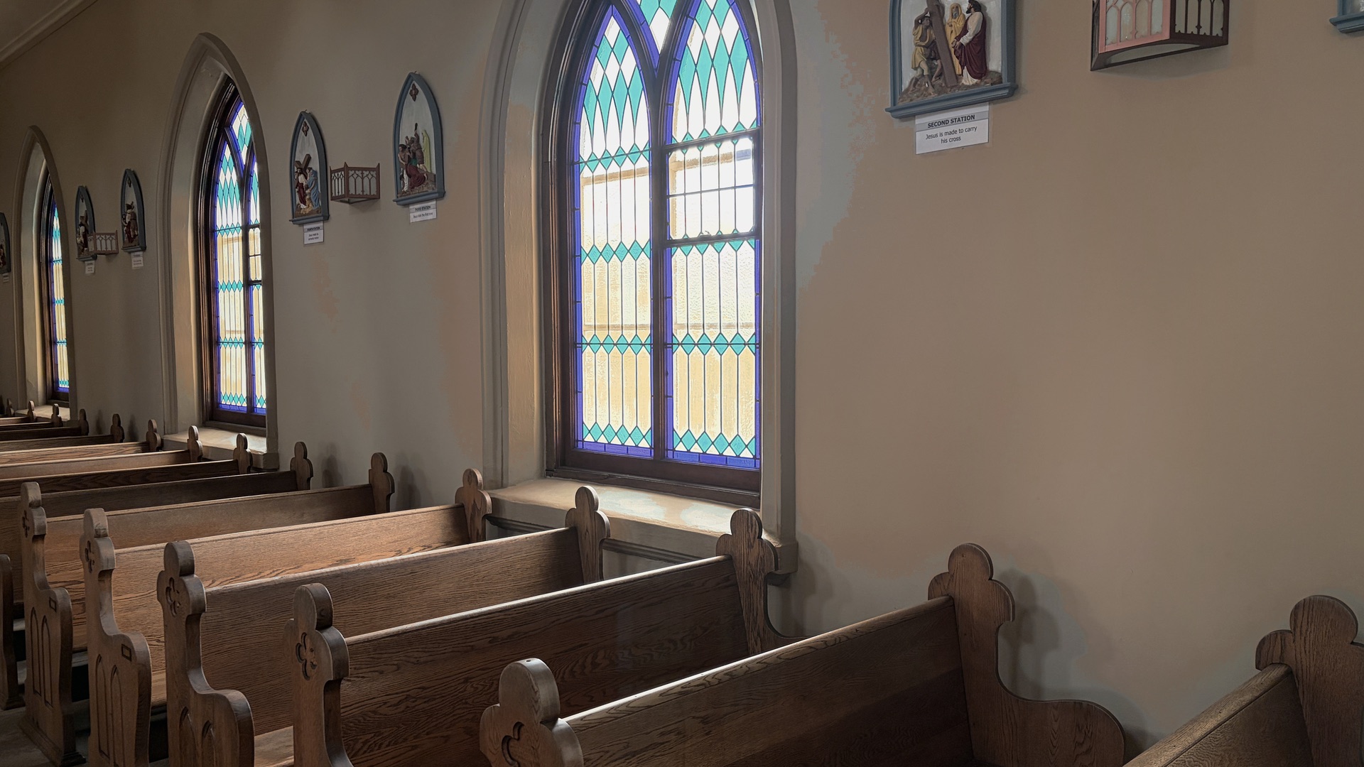 Light through a tall window over the pews