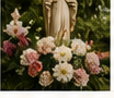 Flowers around a statue of Mary for Mother's Day.